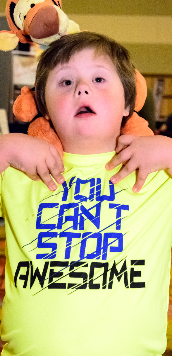 Young attendee wearing shirt that says "you can't stop awesome"