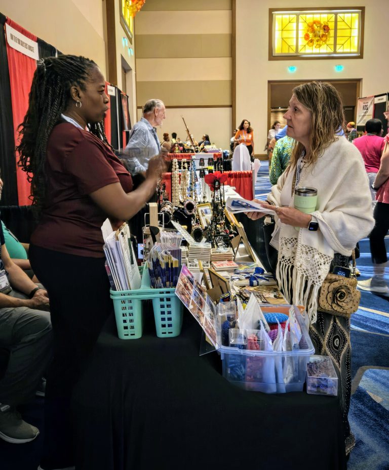 Exhibitor sharing their product with an attendee