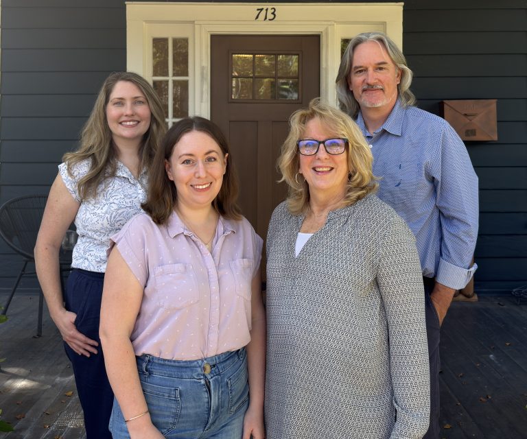 Tanya, Sarah, Lori, and Jeremy standing in front of the office