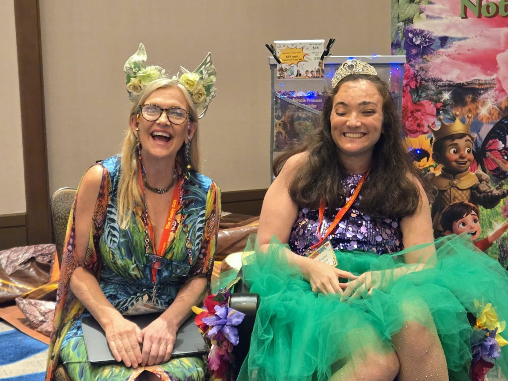 two authors wearing fun green costumes at the book fair